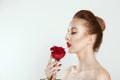 Beautiful as a rose. Girl holding rose Flower in profile side view isolated light grey white background. Beauty Model Woman Face