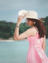 Beautiful Asia female in pink dress on a tropical beach Royalty Free Stock Photo