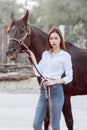 Beautiful Asia girl taking care of her horse with love and caring Royalty Free Stock Photo