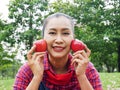 Asia senior woman holding red apple at public park. Royalty Free Stock Photo