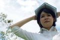 Beautiful Asia woman holding book and thinking idea on sky background. Royalty Free Stock Photo