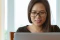 Beautiful asia woman smiling and looking at laptop screen Royalty Free Stock Photo