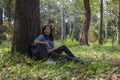 Beautiful asia women sitting drinking water in the forest.