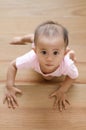 Beautiful asian baby girl while crawling up a stair.