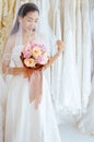 Beautiful asian bride woman holding a bouquet on hand for wedding with feeling shy,Romantic and sweet moment Royalty Free Stock Photo