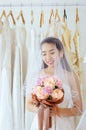 Beautiful asian bride woman holding a bouquet on hand for wedding with felling shy,Romantic and sweet moment