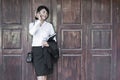 Beautiful Asian business woman calling mobile phone.