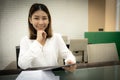 Beautiful asian business woman in close-up shot is confidence in her own sales and sitting while holding tablet with smile. Royalty Free Stock Photo