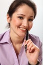 Beautiful Asian business woman holding pen
