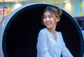 Beautiful asian business woman sitting on a modern round chair smiling at the camera while looking to the copy space. Royalty Free Stock Photo