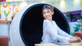 Beautiful asian business woman sitting sideways on a modern round chair appears to be in thought on the table has her phone.