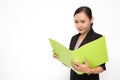 Beautiful Asian business woman wearing black suit look at document folder and smiling on  white background and copy space. Royalty Free Stock Photo