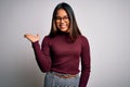 Beautiful asian business woman wearing casual sweater and glasses over white background smiling cheerful presenting and pointing Royalty Free Stock Photo