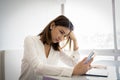 Beautiful asian business woman or working girl is stressed out about her work this month on the desk in her office Royalty Free Stock Photo