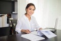 beautiful Asian business women checking document and using notebook and smiling happy for working