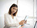 Beautiful asian businesswoman in close up shot sitting and looking to the camera in her office Royalty Free Stock Photo