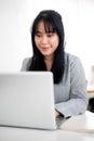 A beautiful Asian businesswoman or female secretary is working on her laptop in a modern office Royalty Free Stock Photo