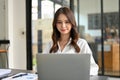 Beautiful Asian businesswoman or female secretary is working in her office, using laptop computer Royalty Free Stock Photo