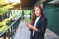An asian businesswoman holding and using mobile phone in the office Royalty Free Stock Photo