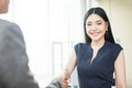 Beautiful Asian businesswoman smiling and shaking hands Royalty Free Stock Photo