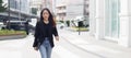Beautiful asian businesswoman wear black suit holding tablet walking city street. woman freelancer lifestyle human urban. Royalty Free Stock Photo