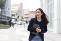 Beautiful asian businesswoman wear black suit holding tablet walking city street. woman freelancer lifestyle human urban. Royalty Free Stock Photo