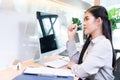 Beautiful Asian businesswoman working in front of her computer in the office Royalty Free Stock Photo