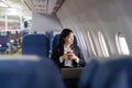 Beautiful Asian businesswoman working with laptop in aeroplane. working, travel, business concept