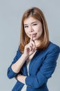 Beautiful asian businesswomanwith cute smile isolated on grey ba Royalty Free Stock Photo