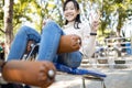 Beautiful asian child girl practicing fitness,doing sit up exercise for health and strength at city park, happy smiling female Royalty Free Stock Photo