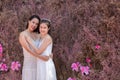 Beautiful Asian couple with wedding dress LGBT women spent time together in park  homosexual announcement relationship for social Royalty Free Stock Photo