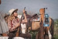 Beautiful Asian cowboy who takes care of her gun and horse with love while at the camp