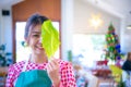 Beautiful asian farmer standing showing organic vegetable leaf with smiling and looking at the camera, Harvesting, Smart farm