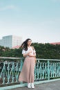 Beautiful Asian female college student holding her books standing outdoor, people education learning program college concept Royalty Free Stock Photo