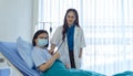 Beautiful asian female doctor using stethoscope checking to elderly patient on the bed at hospital. Medicine and health care safe Royalty Free Stock Photo