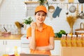 Beautiful asian female employee in an orange uniform is happy to work food delivery .