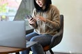 Beautiful Asian female freelancer remote working at the coffee shop co-working space Royalty Free Stock Photo