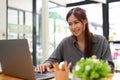 Beautiful asian female office worker working at her office desk, using portable laptop Royalty Free Stock Photo