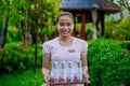 Beautiful asian female spa staff at the spa reception area holding tray with cosmetic product