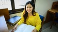 Beautiful asian female student reading book, doing class assignment. in library. Education, learning and people concept Royalty Free Stock Photo