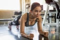 Beautiful Asian fitness young woman in sportswear doing plank in gym . sport Fit girl push up exercise in morning . healthy Royalty Free Stock Photo