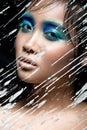 Beautiful Asian girl with bright blue make-up Royalty Free Stock Photo