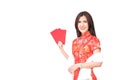 Beautiful Asian girl in Chinese qipao traditional dress, holding red money pockets or greeting card envelopes Royalty Free Stock Photo