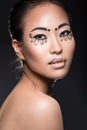 Beautiful Asian girl with a creative makeup, unusual eyelashes paper. Beauty face.