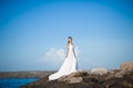 Beautiful Asian girl dressed in white dress enjoying sea breeze by the sea Royalty Free Stock Photo