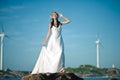 Beautiful Asian girl dressed in white dress enjoying sea breeze by the sea Royalty Free Stock Photo