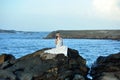 Beautiful Asian girl dressed in white dress enjoying sea breeze by the sea Royalty Free Stock Photo