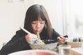 Asian girl eating chashu ramen in japanese restaurant