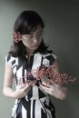 Beautiful Asian girl with glasses holding flower buds in her arms Royalty Free Stock Photo