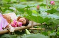 1.Beautiful Asian lady has a daydream near the lotus pond in blooming season